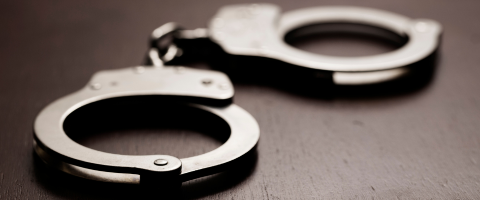 A pair of handcuffs on a surface